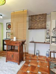 a room with a wooden desk and a table at Farm Cottage in Hong Kong