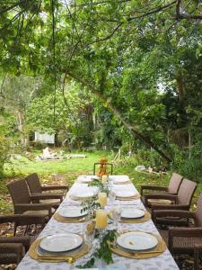 a long table with plates and glasses on it at Farm Cottage in Hong Kong