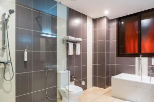 a bathroom with a shower and a toilet and a sink at Hotel 33 Kampala in Kampala +47 photos