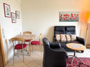 a living room with a couch and a table at Strandvilla Therese Appartment 5 in Norderney