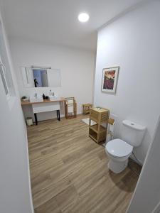 a bathroom with a toilet and a sink at The Yellow Cottage in Lomba de São Pedro +36 photos