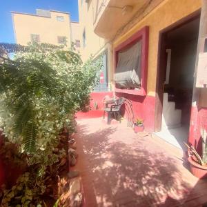 a patio with a table and chairs in a building at Studio Relax in Dakhla +3 photos