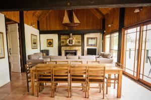 a dining room with a large wooden table and chairs at Peppers Creek Accommodation in Pokolbin