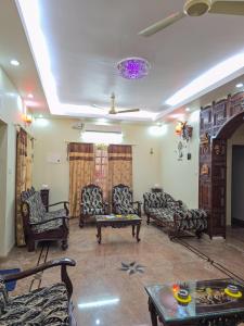 a living room with couches and a table at Spacious 2 Bedroom Private House in Mangalore Fully Air-Conditioned, WiFi & Parking in Mangalore +31 photos