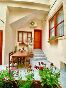 a patio with a wooden table and a house at Antalya Inn Hotel in Antalya