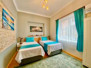 a bedroom with two beds and a window at Antalya Inn Hotel in Antalya +87 photos