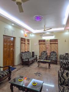 a living room with couches and a table at Spacious 2 Bedroom Private House in Mangalore Fully Air-Conditioned, WiFi & Parking in Mangalore