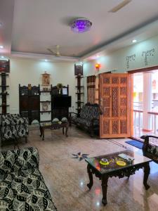 a living room with couches and a coffee table at Spacious 2 Bedroom Private House in Mangalore Fully Air-Conditioned, WiFi & Parking in Mangalore