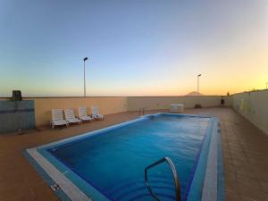 a large swimming pool on top of a building at RenTenerife EspebelBeach in El Médano