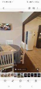 a picture of a kitchen with a table and a refrigerator at Rafa y Nelly 2 in San Clemente del Tuyú