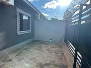 an empty room with a window and a tile floor at Elvara's Nest in Lusaka