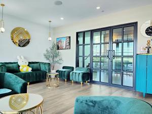 a living room with a green couch and chairs at โคโค่ โฮเทล KOCO Hotel in Nakhon Ratchasima