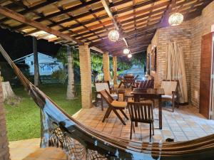 a patio with a table and chairs on a deck at Chalé Paraíso, Praia da Pipa in Pipa