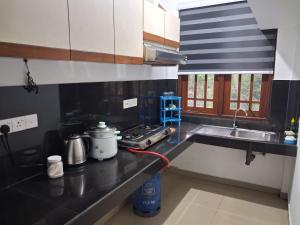 a kitchen with a sink and a counter top at Slayan properties in Mudungoda +10 photos