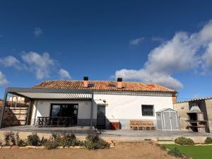 a large white building with a roof at Campos de Villalba in Villalba