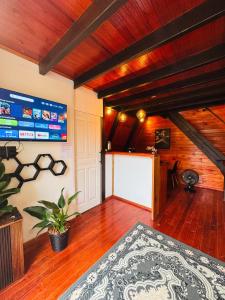 a room with a bed and a tv on the wall at Recanto Porto Chalé e SPA in Penha