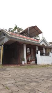 a large house with a porch and a porch at Spacious 2 Bedroom Private House in Mangalore Fully Air-Conditioned, WiFi & Parking in Mangalore
