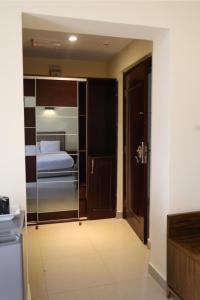 a room with a bedroom with a bed and a door at Golden Alpine Hotel in Yola +10 photos