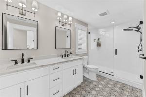 a white bathroom with a sink and a toilet at 921 Asbury Ave, Unit C in Ocean City +32 photos