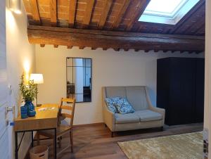 a living room with a chair and a table at Podere Misericordia in Ferrara