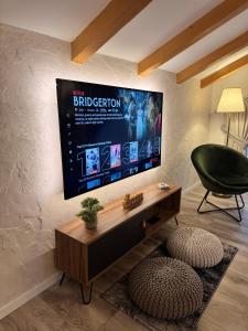a living room with a flat screen tv on a wall at QUEEN’S HEART GUESTHOUSE in Bran +81 photos