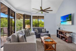 a living room with a couch and a table at Grand Champions 124 · GC 124 3BD Wailea Condo wAC Pool Hot Tub in Wailea