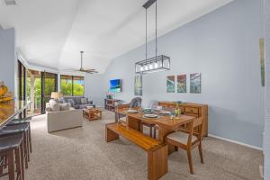 a living room with a table and a couch at Grand Champions 124 · GC 124 3BD Wailea Condo wAC Pool Hot Tub in Wailea