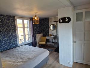 a bedroom with a bed and a desk and a window at Vallee du Ton in Origny-en-Thiérache