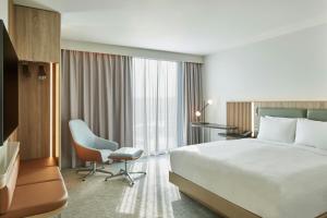 a hotel room with a bed and a desk and a chair at Courtyard by Marriott Sheffield in Sheffield