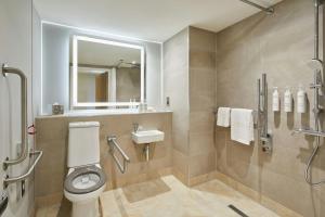 a bathroom with a toilet and a sink and a shower at Courtyard by Marriott Sheffield in Sheffield +17 photos