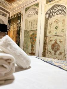a close up of a bed in a room at Boutique ALISHER in Bukhara