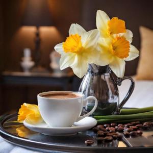 a cup of coffee and a vase of flowers on a tray at Logies Zen aan Zee in Ostend