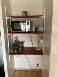 a kitchen with a microwave and a coffee maker at Chez Nathou in Janzé +4 photos