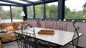 a living room with a table and a couch at La Pause in Craponne
