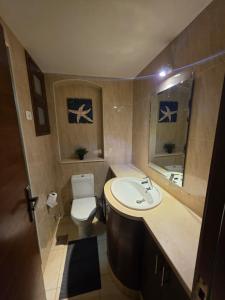 a small bathroom with a sink and a toilet at Blue haven el gouna in Hurghada +11 photos