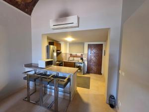 a kitchen with a counter and some stools in it at Blue haven el gouna in Hurghada
