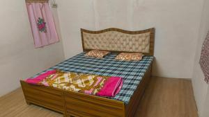 a bed with two pillows on it in a room at Arihant Guest House in Ujjain