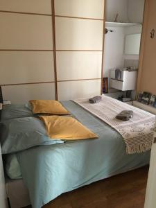 a bed with two pillows on it in a room at La Pause in Craponne