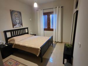 a bedroom with a bed in a room with a window at Blue haven el gouna in Hurghada