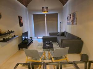 a living room with a couch and a table and chairs at Blue haven el gouna in Hurghada