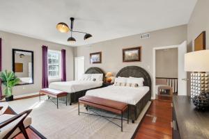 a bedroom with two beds and a table at Oglethorpe Estate in Savannah +105 photos