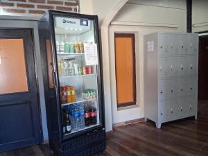 a refrigerator in a room with drinks in it at Hostel Lagos del Sur in El Chalten