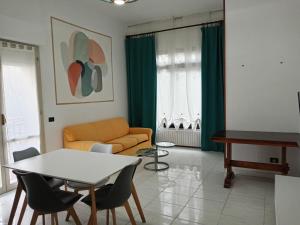 a living room with a couch and a table at Colibrì in Bordighera