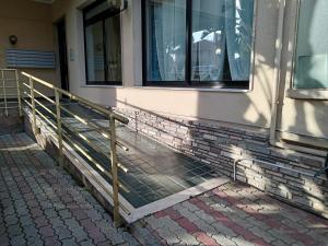 a railing next to a building with a window at Colibrì in Bordighera +2 photos