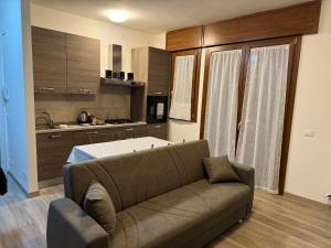 a living room with a couch and a kitchen at Tarvisium Apartment in Treviso +7 photos