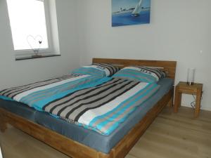 a bed with a wooden headboard in a room at Marktperle in Sagard +22 photos