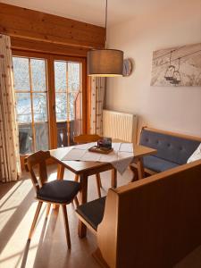 a living room with a table and a couch at Hof Oberhaus in Kitzbühel