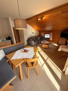 a living room with a table and a couch at Hof Oberhaus in Kitzbühel