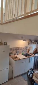 a kitchen with white cabinets and a counter top at Le refuge de Teddy in Solliès-Toucas +16 photos