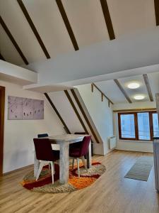 a dining room with a table and some chairs at The Pine Loft by Kopaonik in Kopaonik